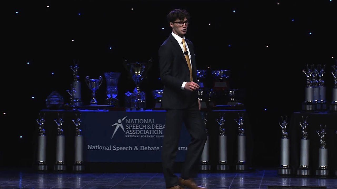A champion on stage at the National Speech & Debate Tournament awards ceremony